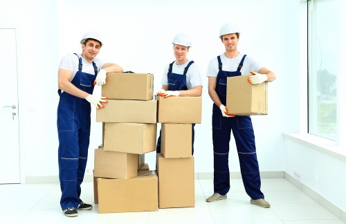 Staff organising furniture and archive boxes during an office relocation