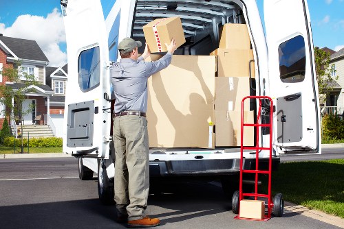 House movers carefully carrying furniture from a Bromley home