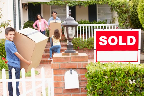 Local moving team transporting boxes in Bromley